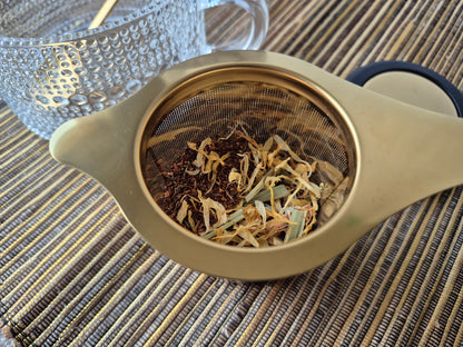 Gold infuser and rooibos tea closeup